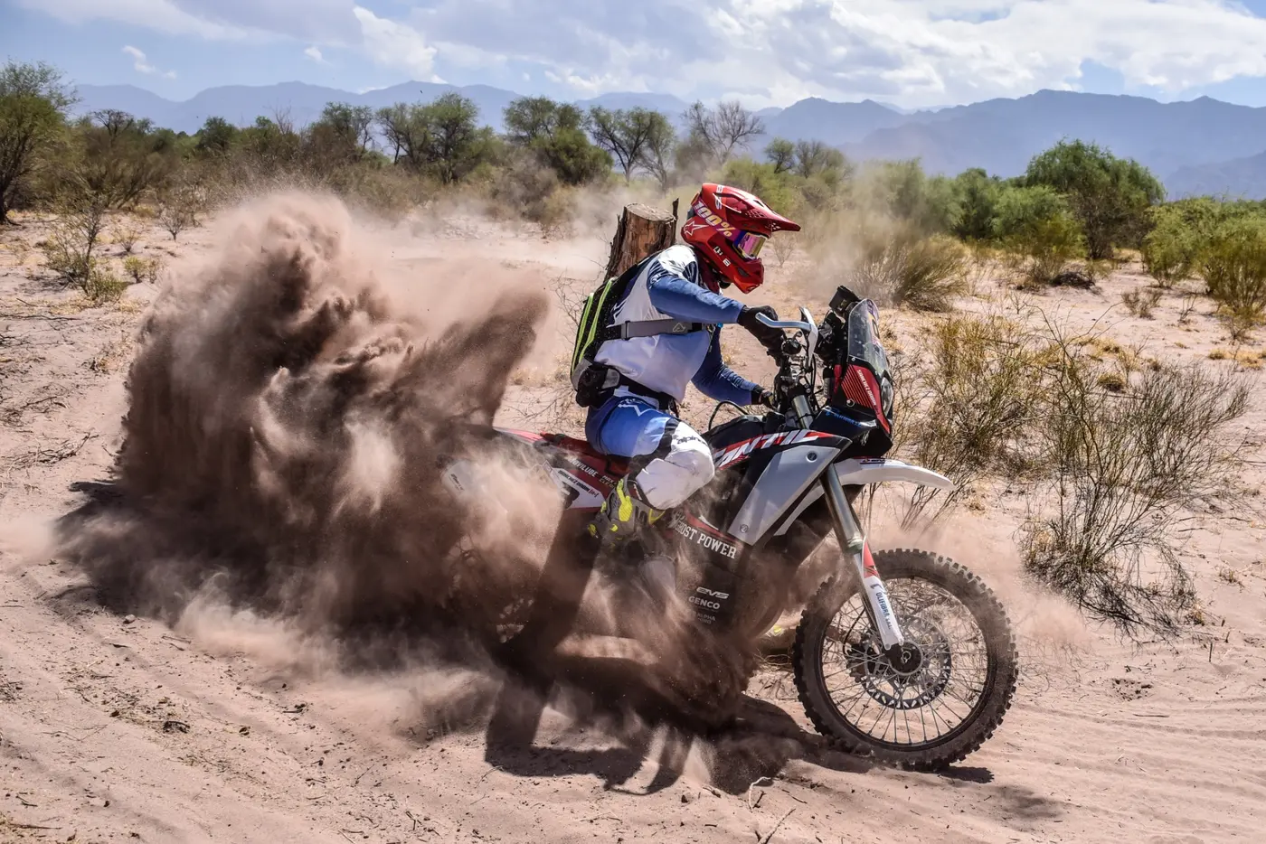 Motociclista compitiendo en terreno arenoso